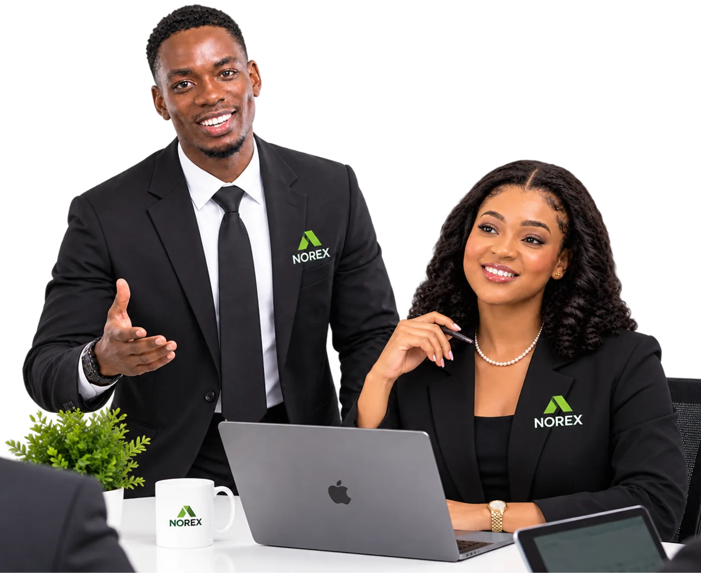 Two Norex team members in suits at a desk with a laptop, one gesturing as he explains