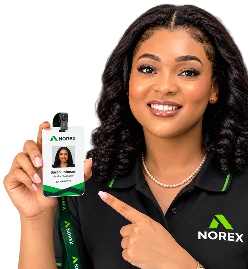A Norex team member holding up a staff ID card and pointing at it